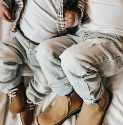 Slate Gray Denim Pants | Orcas Lucille jeans on babies lying down together on a bed