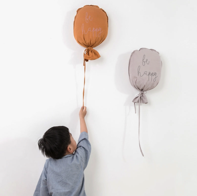 Balloon Pillow Decor | Ziaplayalong little boy holding reusable sustainable balloons for first birthday