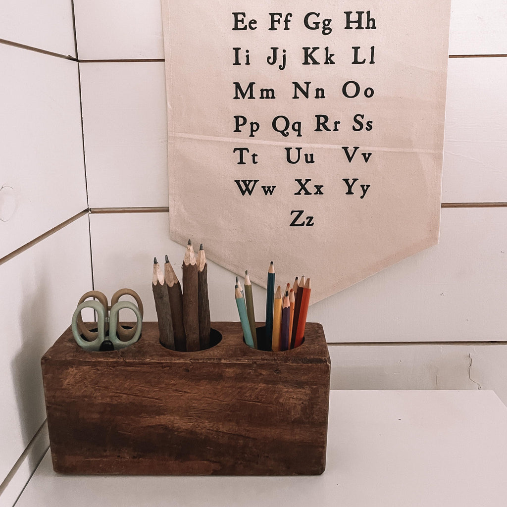 White shiplap wall with an alphabet banner, and the Wooden Crayon Holder in Small | 3 Holes by Forever Green Art.