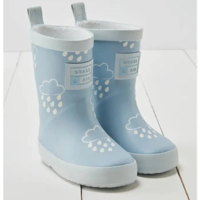Colour Changing Rain Boots by Grass & Air in Light Blue on a white wood surface. 