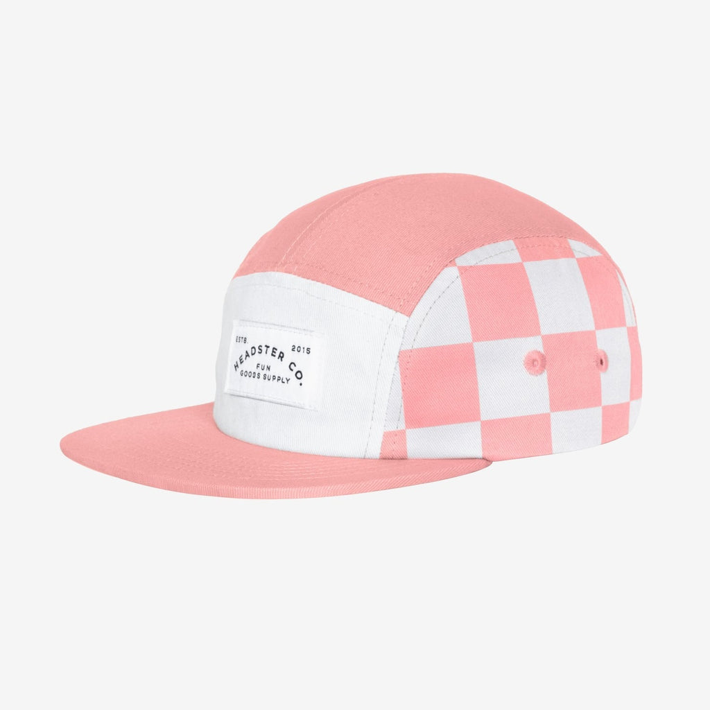 Check Yourself Five Panel Peaches Hat by Headster, white background and surface. 