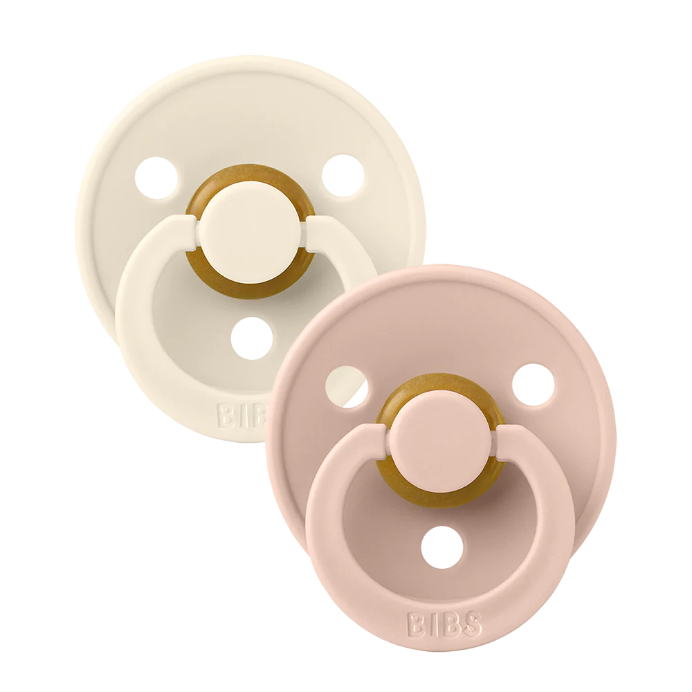 Clear background with the Size 2 Pacifiers in Ivory & Blush by Bibs. Set includes one ivory, and one blush pacifier.