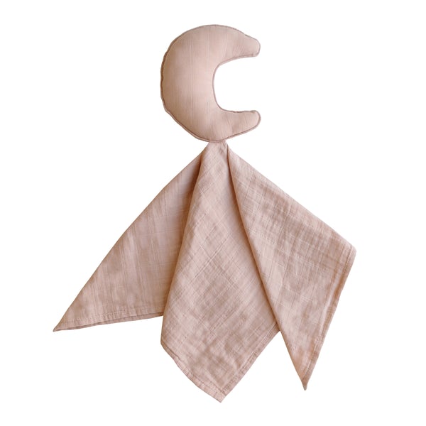 White background with a Lovey in Moon/Blush by Mushie. Lovey has a stuffed moon, with a muslin blanket attached in a blush colour.