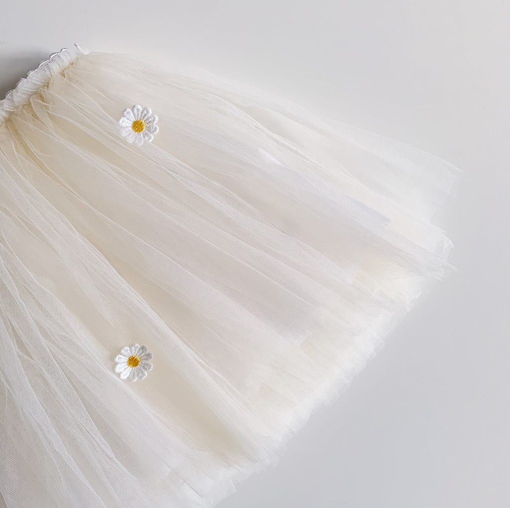 Close up of Cream Tutu with little embroidered white daisies with a yellow center by Bluish