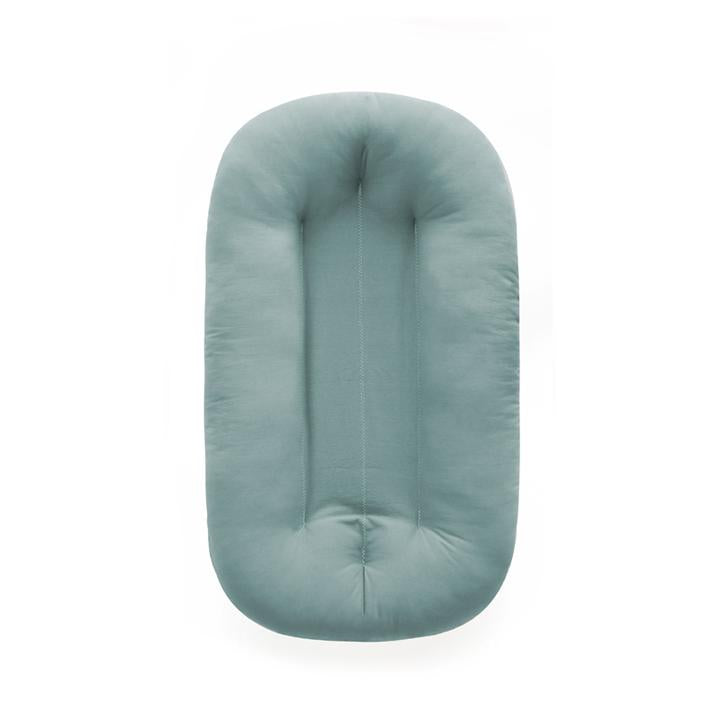 White background with the Snuggle Me Organic Infant Lounger in Slate by Snuggle Me. Lounger is a blue/grey colour.