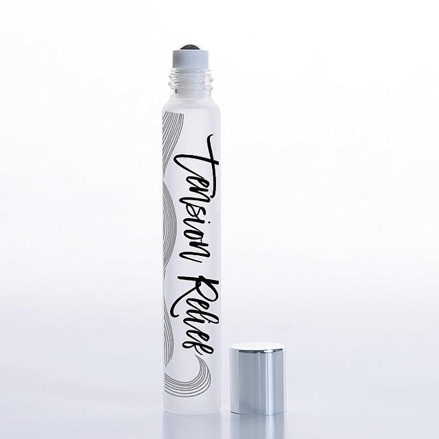 White background with a rollerball of Tension Relief Essential Oil Blend by Jane + Thunder,