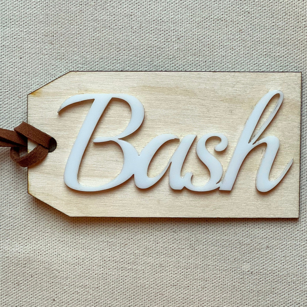 Customized name tag in Cloud with the name Bash on a beige surface. 