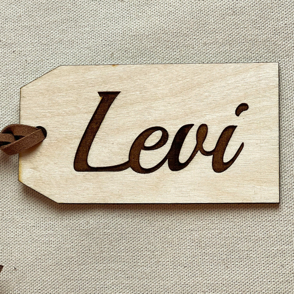 Customized name engraved with the name Levi on a beige surface. 