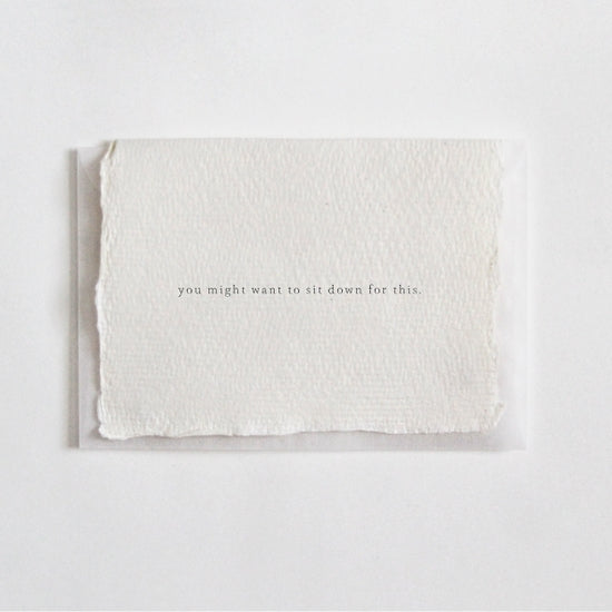 Cotton Rag Paper card that reads "you might want to sit down for this." in typewriter font by Belinda Love Lee Paperie