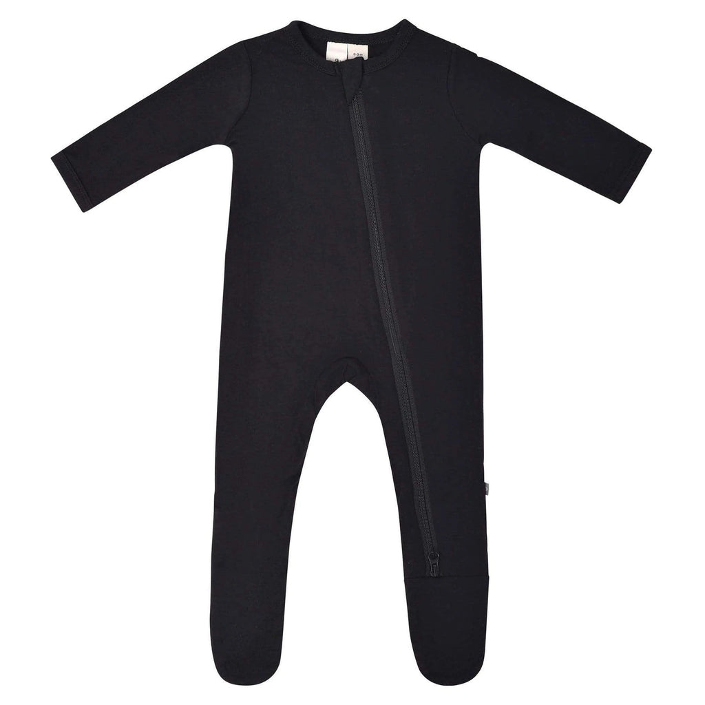 White background with a Zippered Footie in Midnight by Kyte Baby. Zippered footie in black with a zipper going down the front.