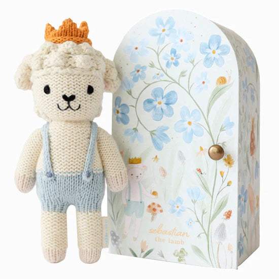 beige lamb with blue overalls and rust crown