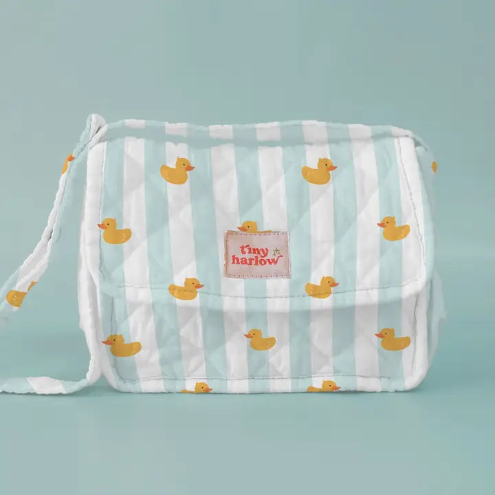 flatlay of duck nappy bag on blue background 