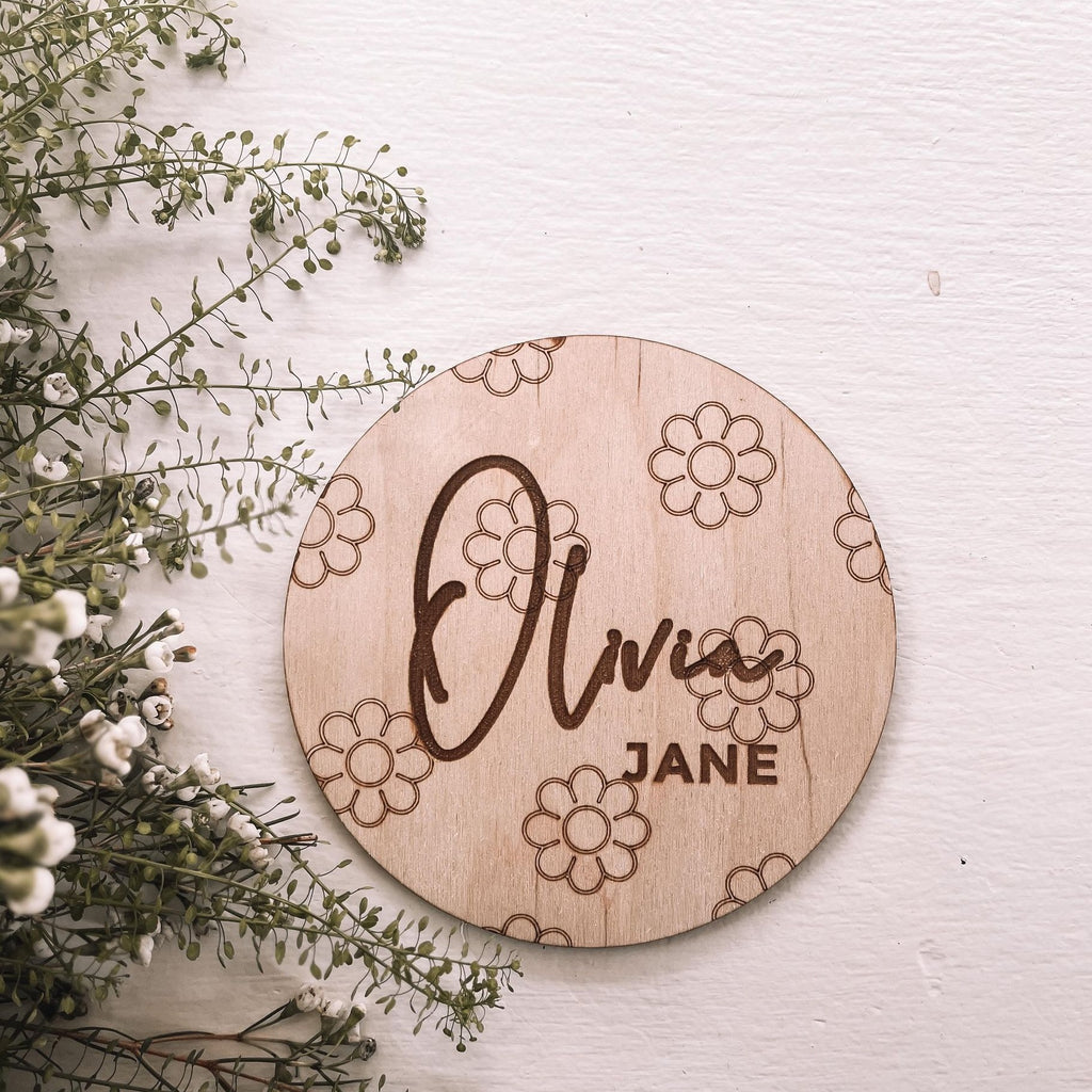 name disc with daisies background next to wildflowers 