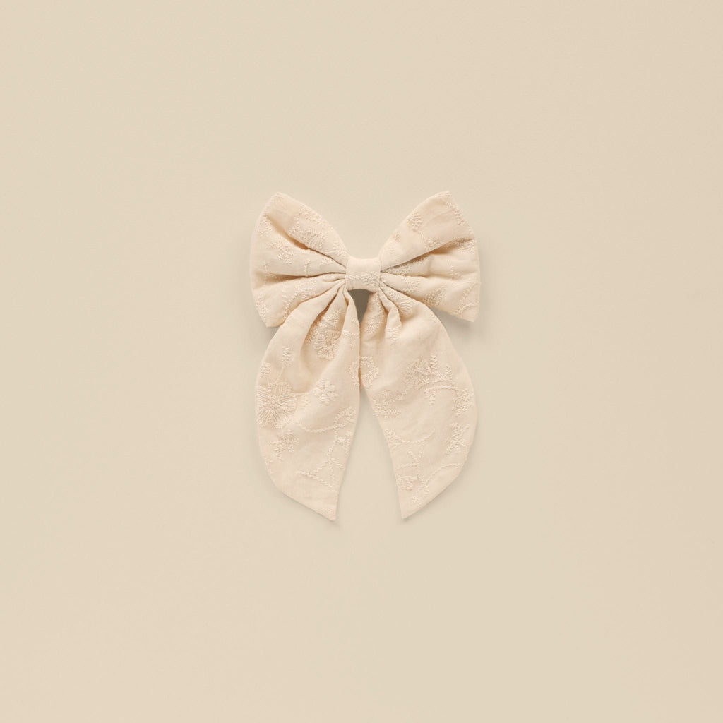 flatlay of oversized bow in natural 