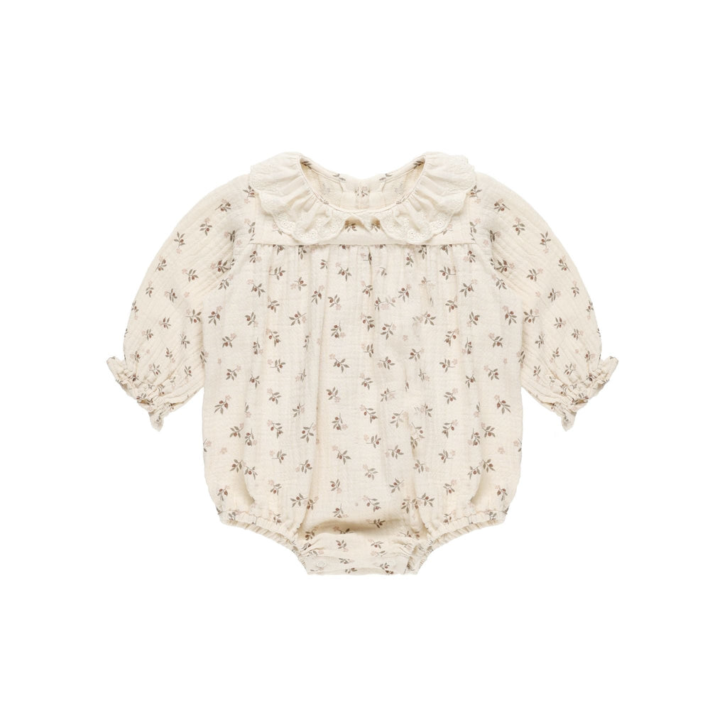 flatlay of collared bubble romper on white background 