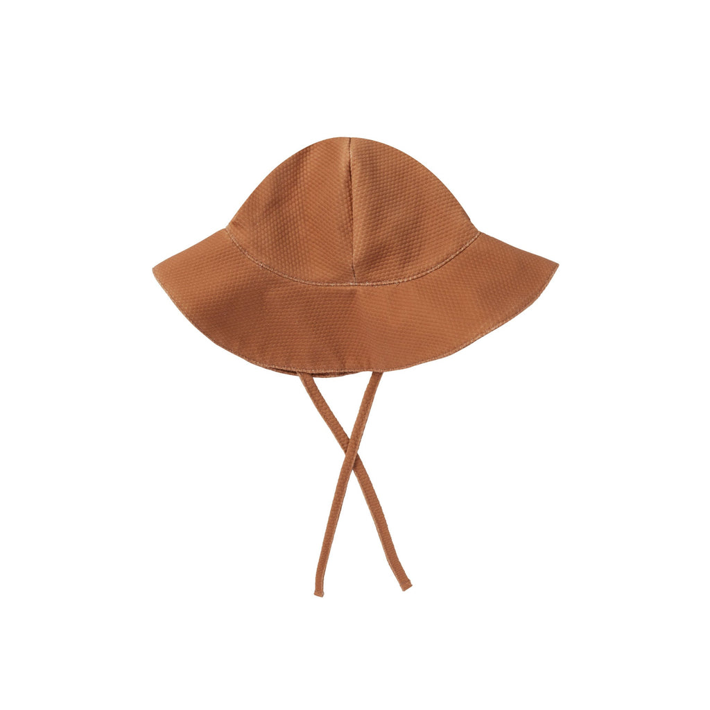 flatlay of clay hat on white background 