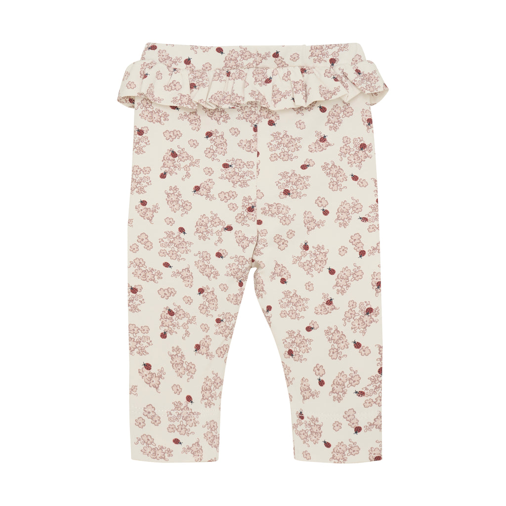 cream leggings with lady bugs and ruffle flat lay