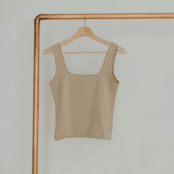 beige tank on gold rack 