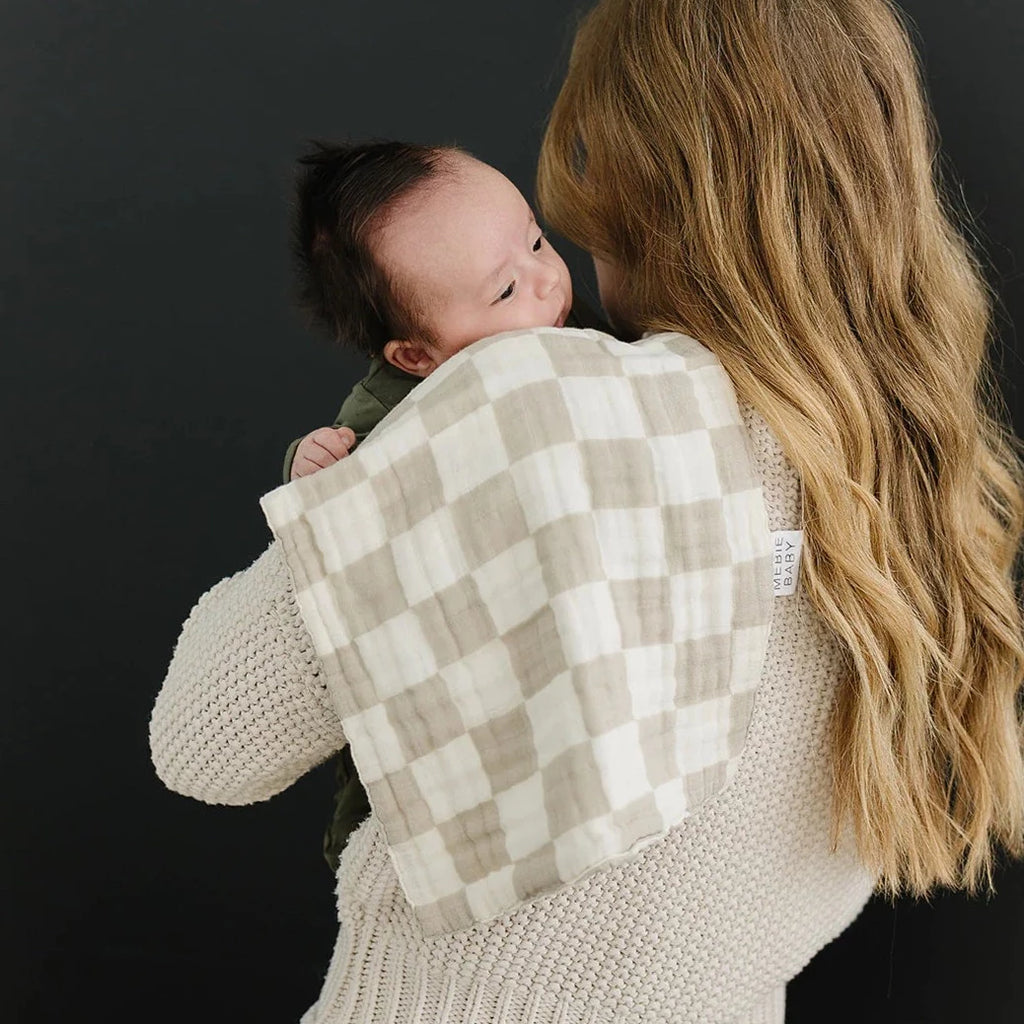 Taupe Checkered Burp Cloth by Mebie Baby mom with long curly blonde hair holding newborn baby on shoulder with burb cloth