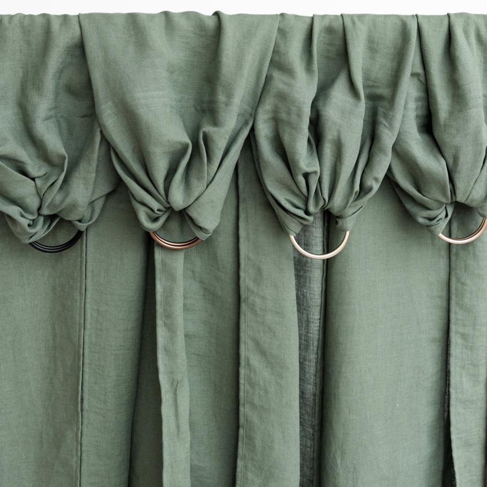 flatlay of linen green sling on white background 