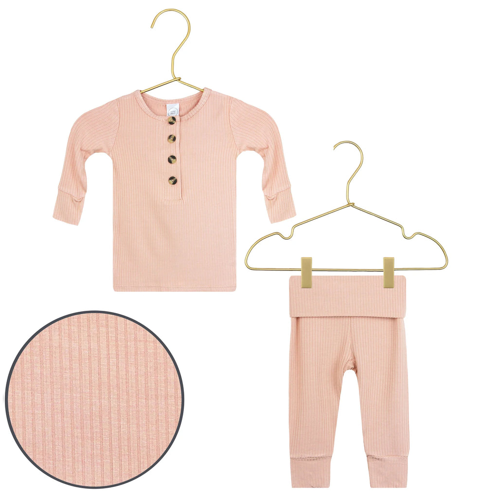 flatlay of aurey pink set top and bottom white background