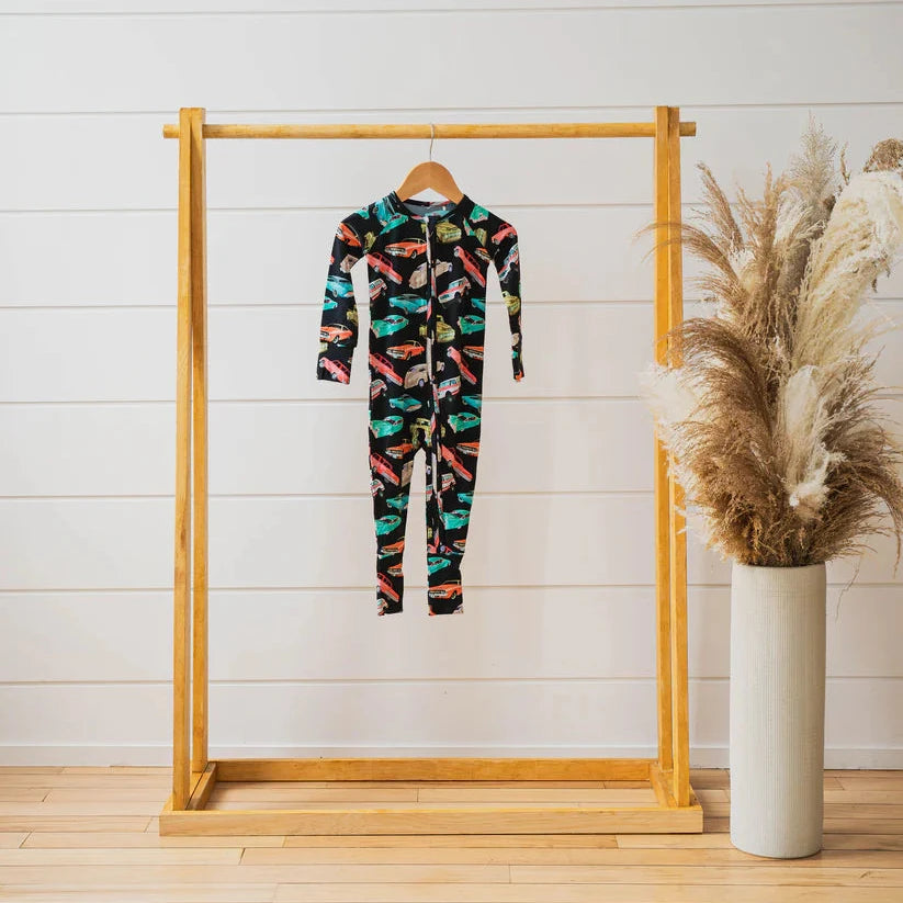 car romper on wood dowel rack with plant 