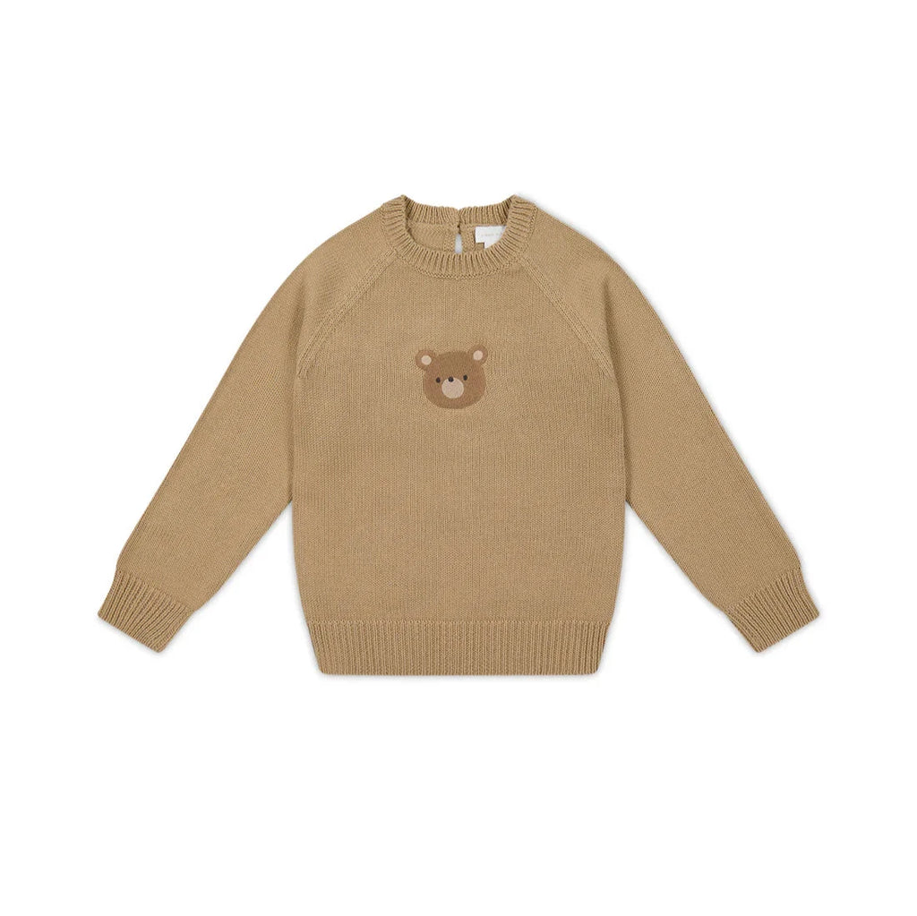 flatlay of sweater with bear on it 