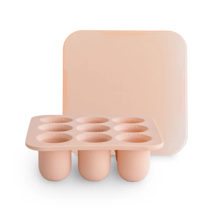 flatlay of blush tray feeder on white background 