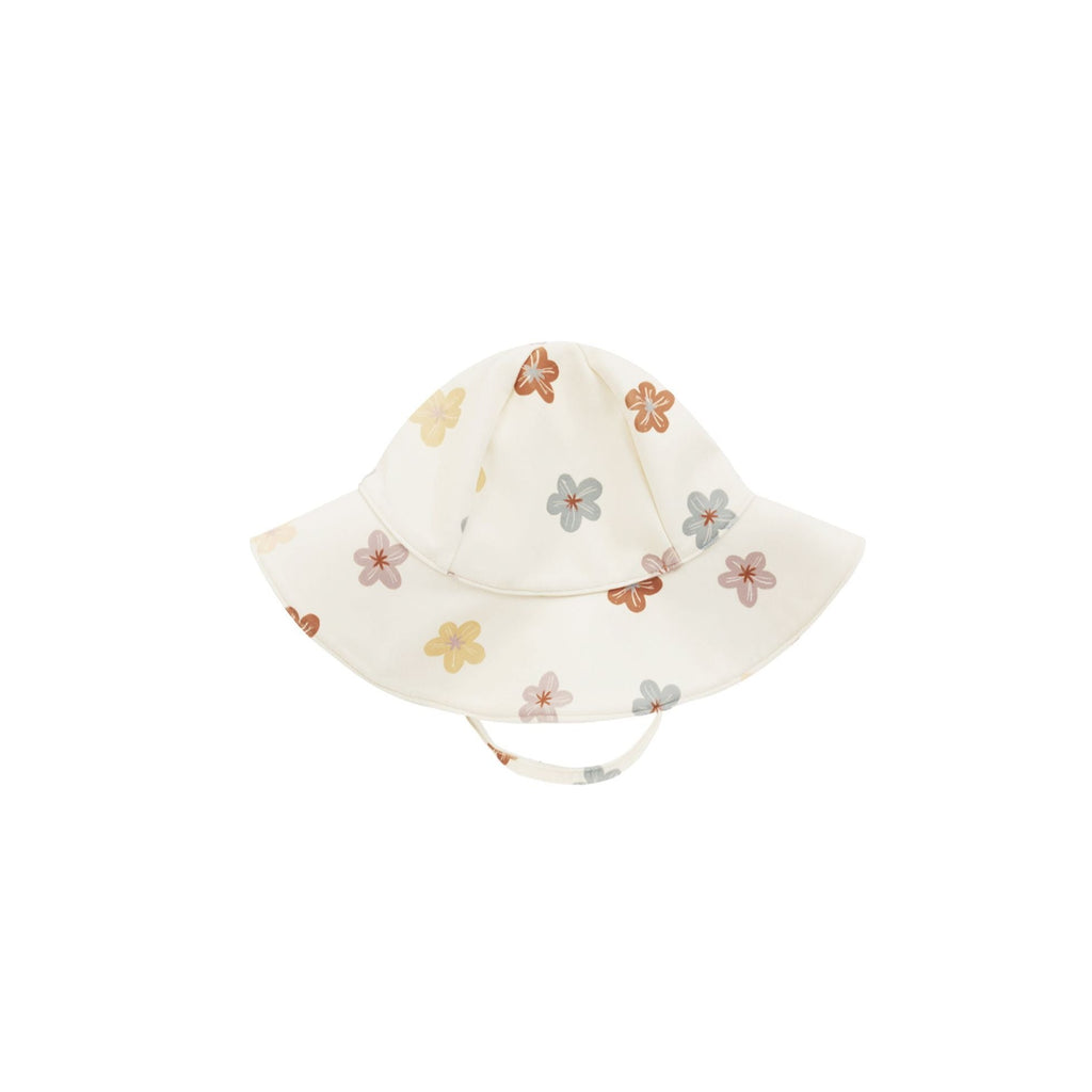 sun hat with flowers flatlay white bagkround