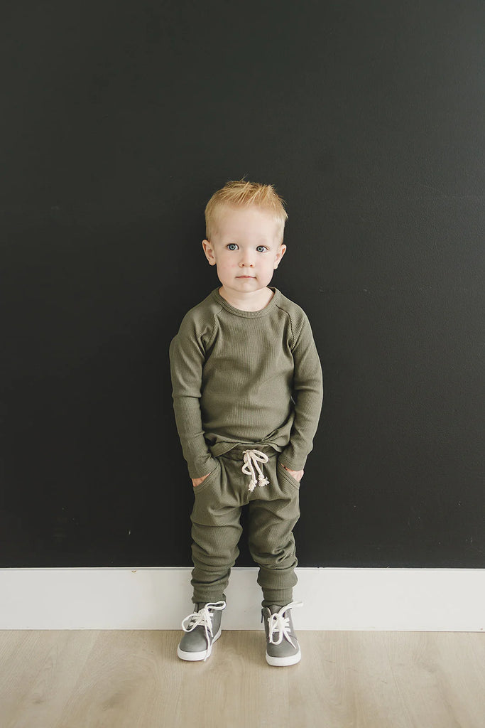 toddler standing on balck background