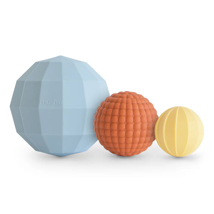 nesting sphere blue orange and yellow on white background flatlay 