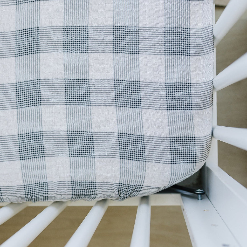 flatlay of coastal blanket on crib 