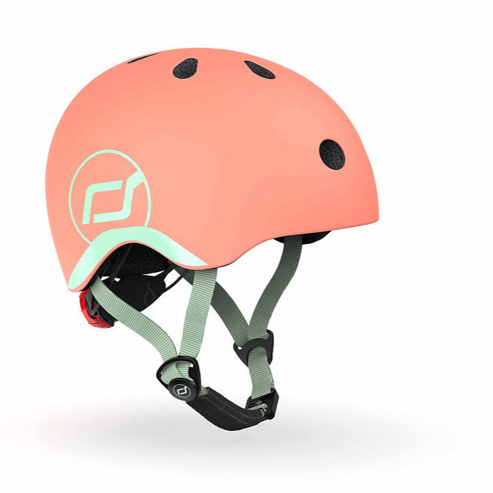 Peach helmet with green strap