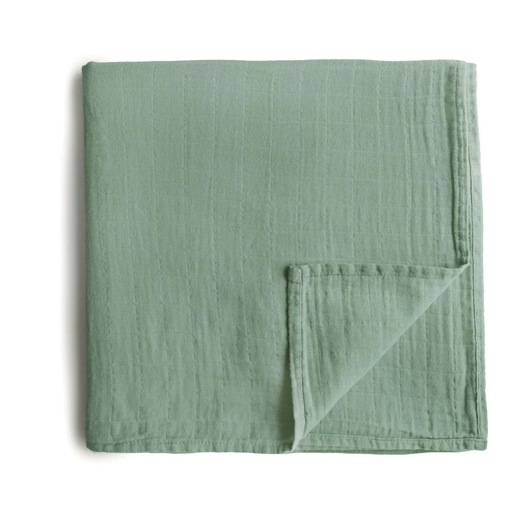 flatlay roman green swaddle blanket