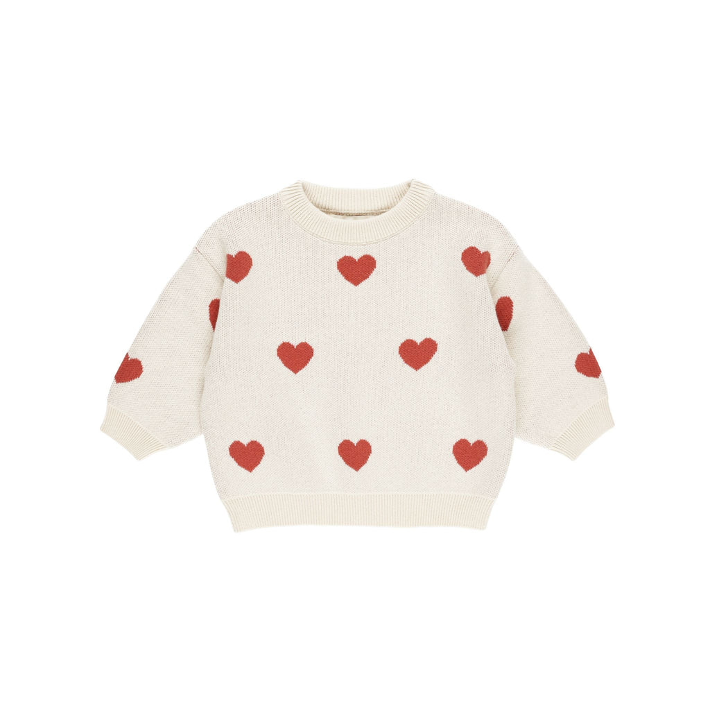 flatlay of knit heart sweater on white background 