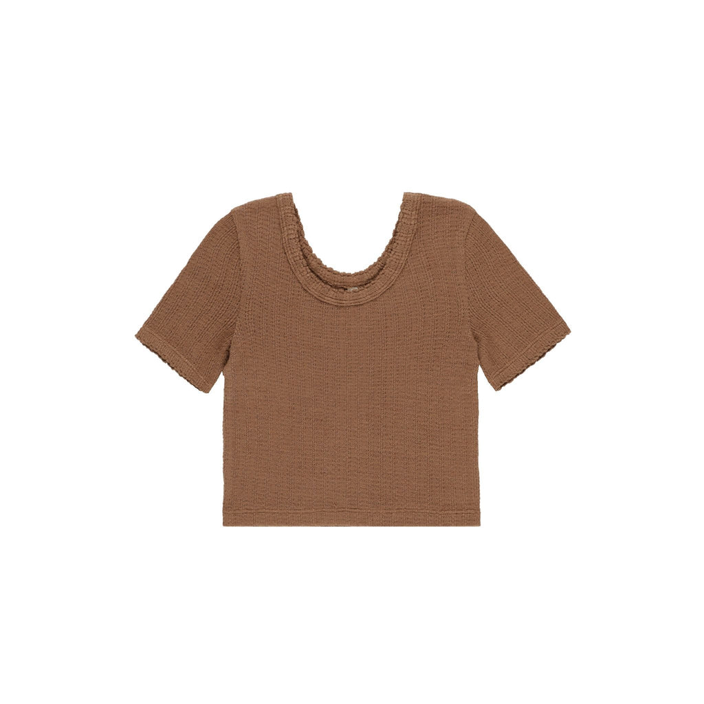 flatlay of brown scalloped tee on white background 