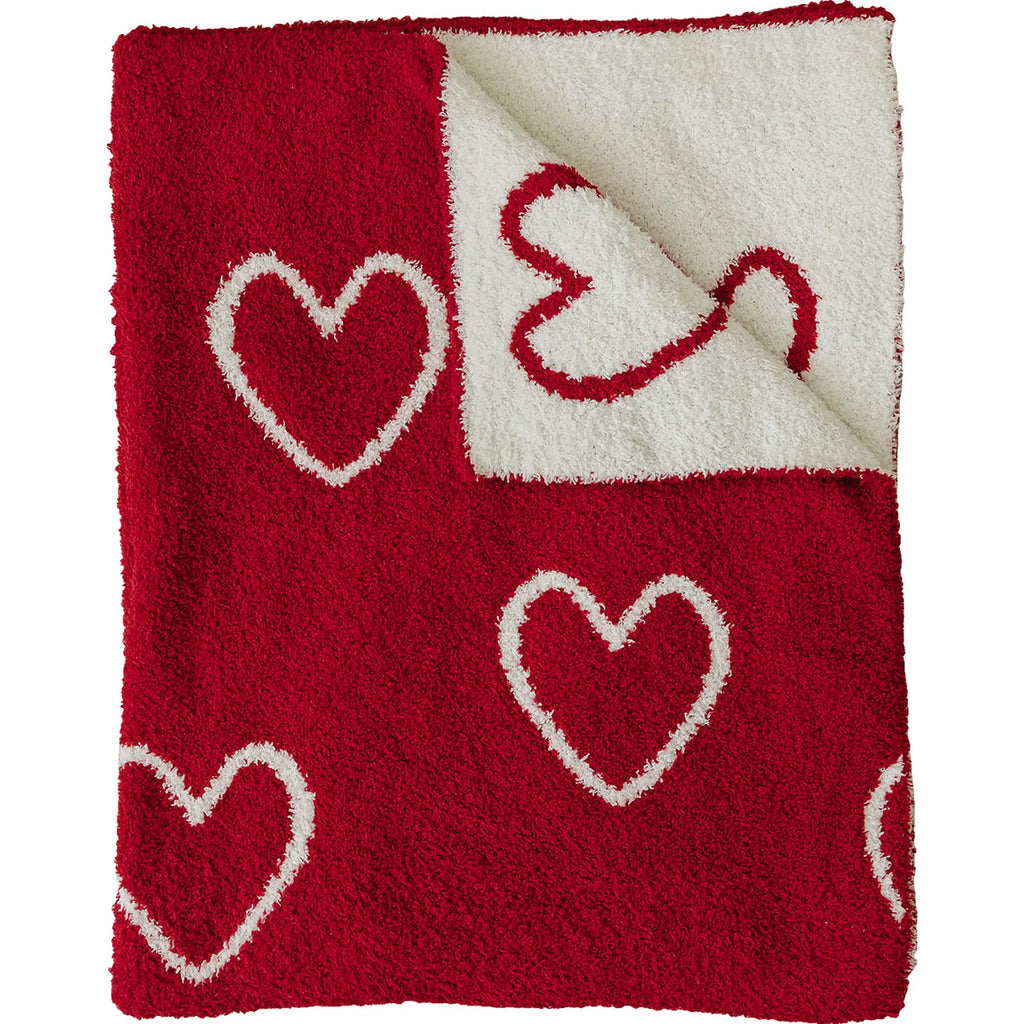 flatlay of plush heart blanket on white background 