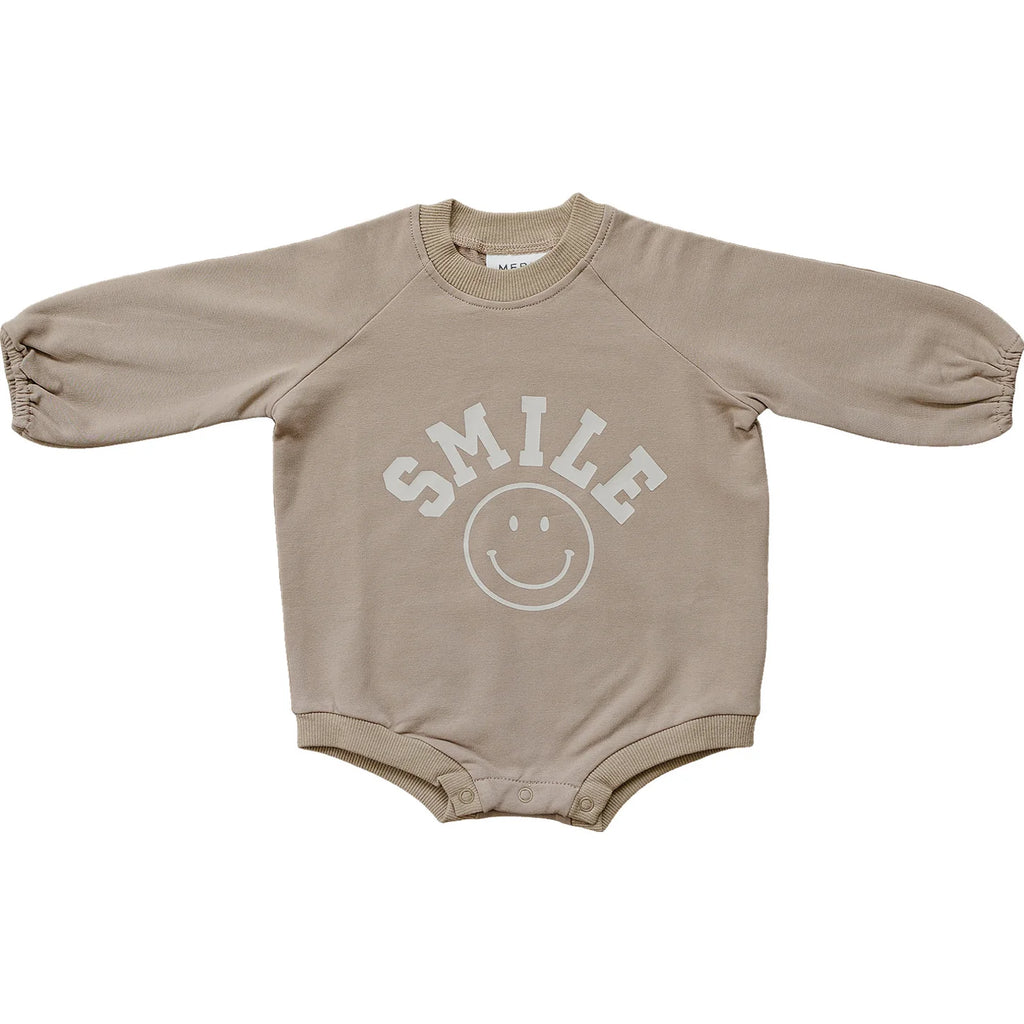 flatlay of smile bodysuit on white background 