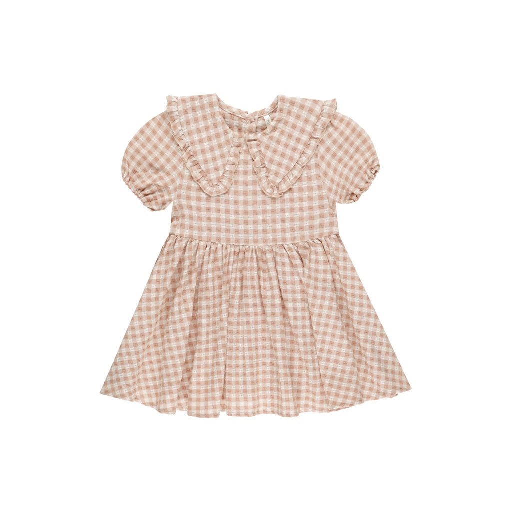 flatlay of gingham dress on white background 