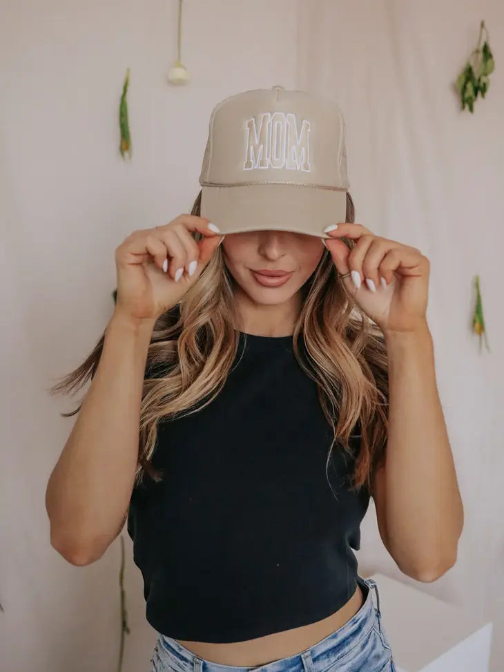 MOM snapback || by Charlie Southern on a woman holding the ends of the hat smiling down black t-shirt