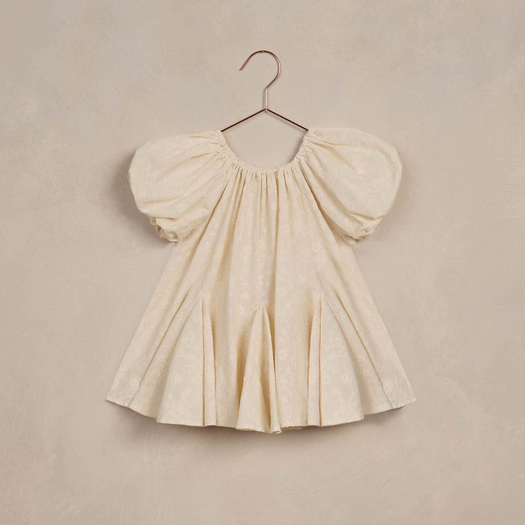 maia dress flatlay beige background 