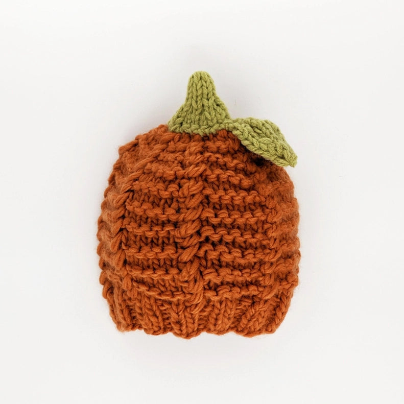 flatlay of pumpkin hat on white background 