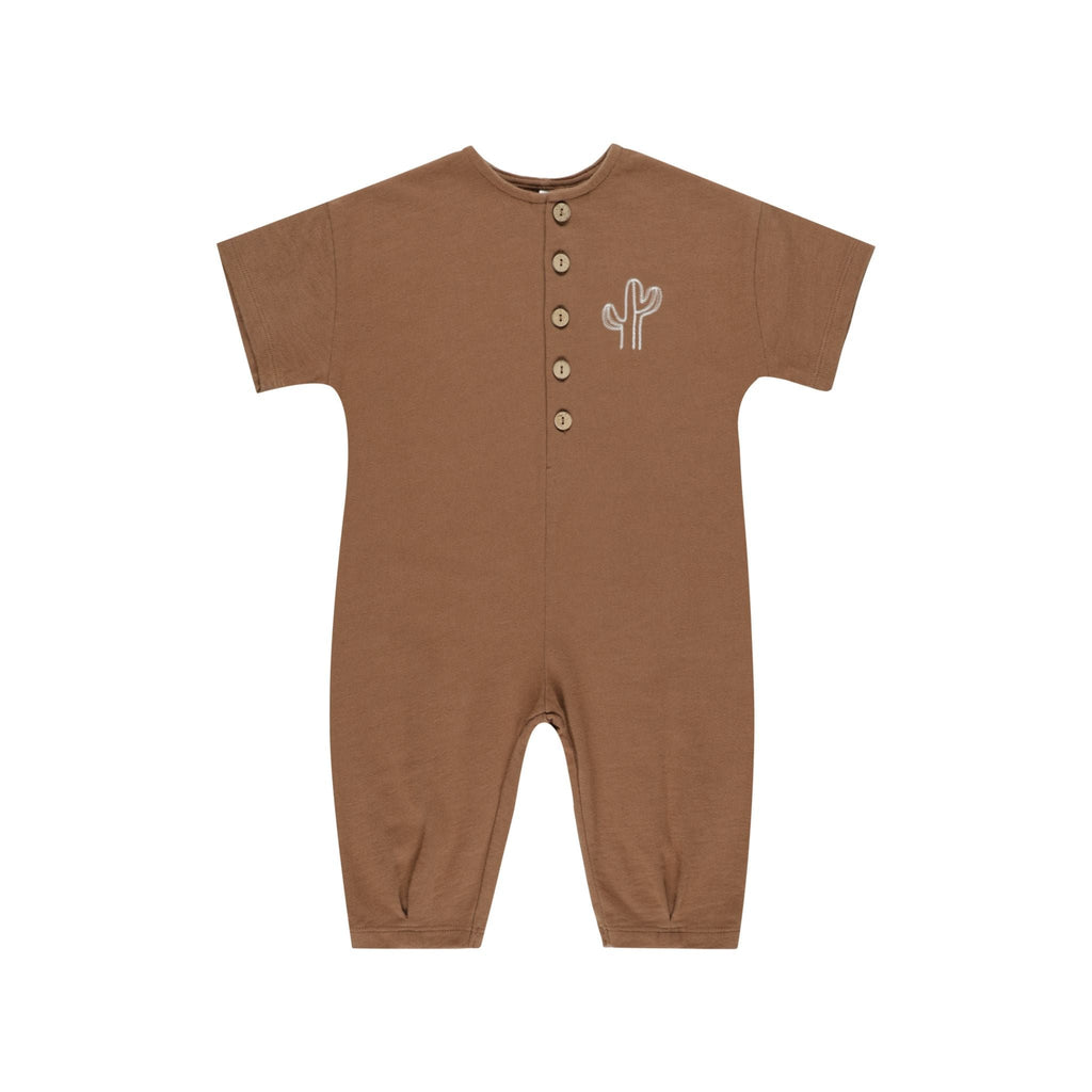 flatlay saddle romper on white background 