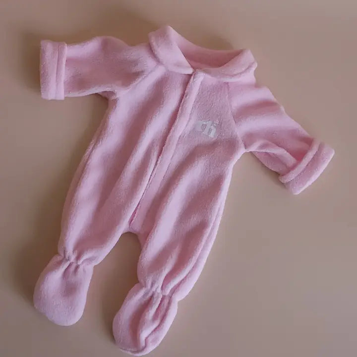 flatlay of baby pink onepiece doll outfit 