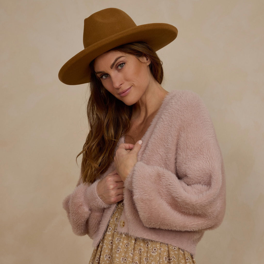 blush sweater on women wearing brown hat 