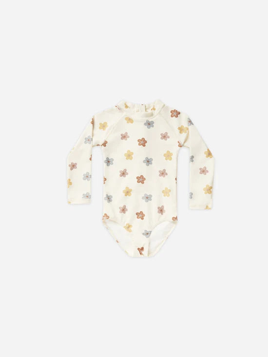 flatlay of one piece swimsuit with hibiscus on white background