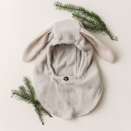 flatlay of bunny hood with greenery white background 