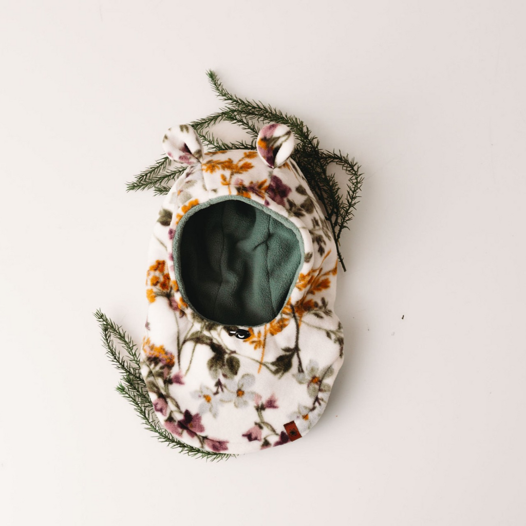 flatlay of floral animal hood on white background 