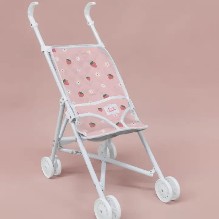 flatlay of strrawberry stroller pink background 