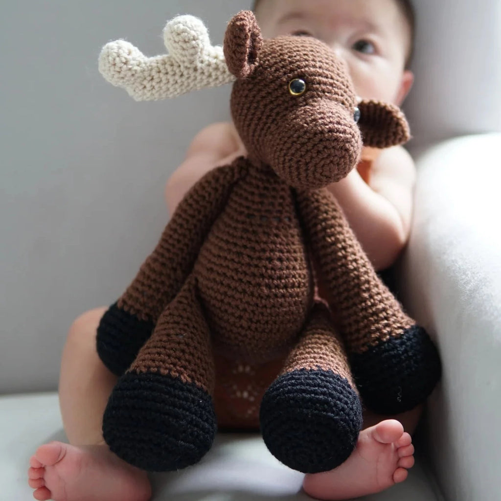moose stuffy in baby's arm 